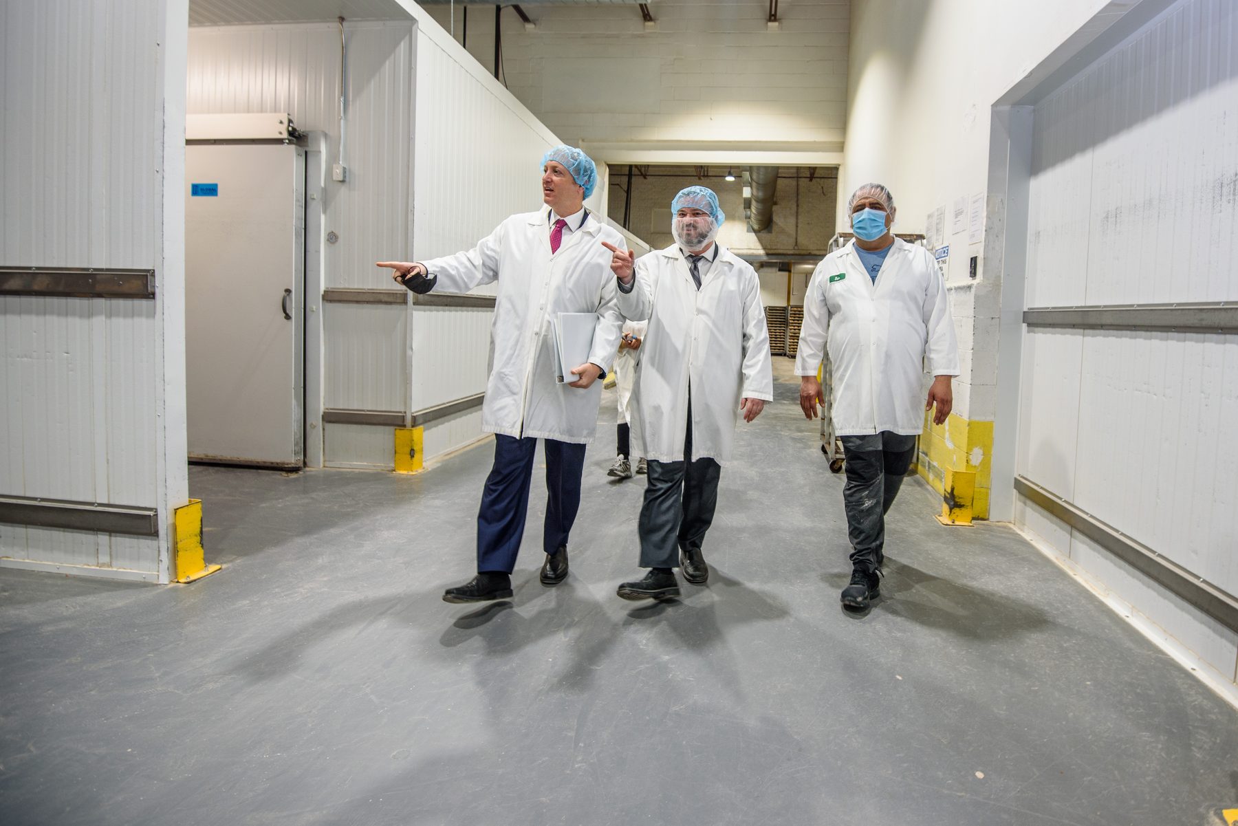 VegeCert inspectors walking through a manufacturing facility during a certification review